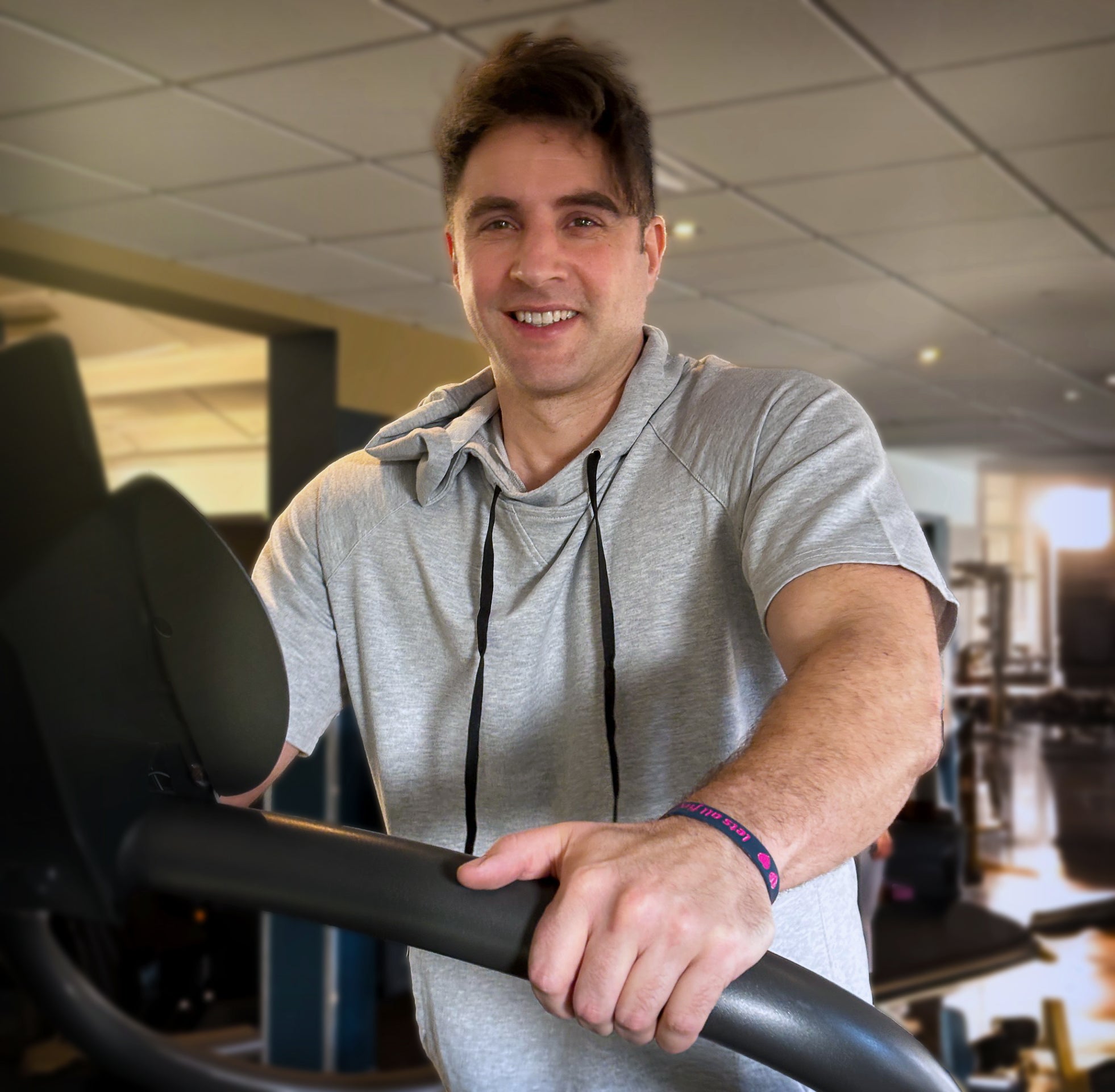 Attractive guy working out wearing his let’s all find love wristband